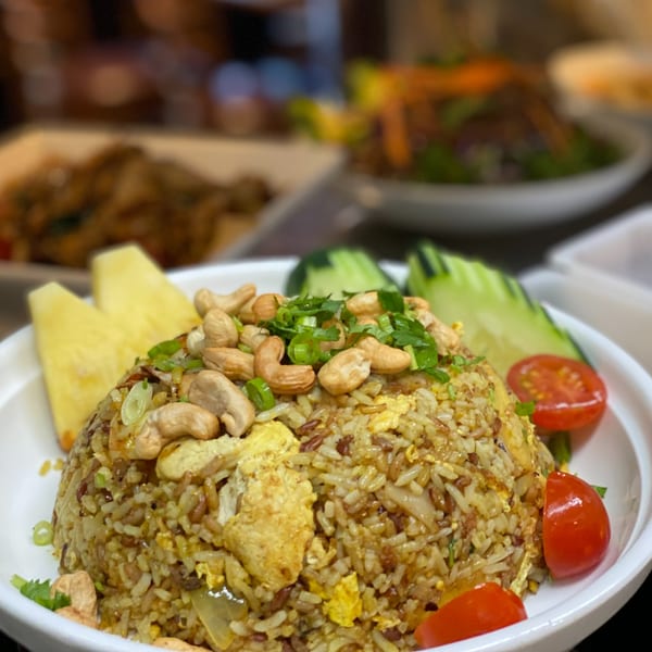 Thai Basil's pineapple fried rice with cashews, green onions, pineapple slices, and cherry tomatoes.
